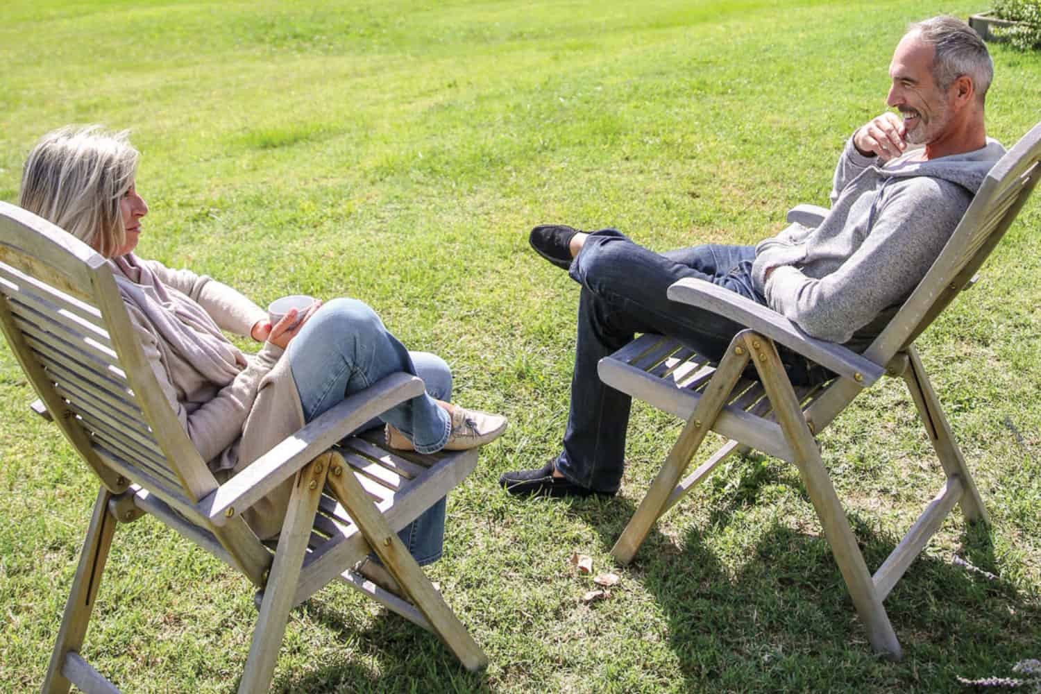 Retired couple sitting in chairs in a vineyard