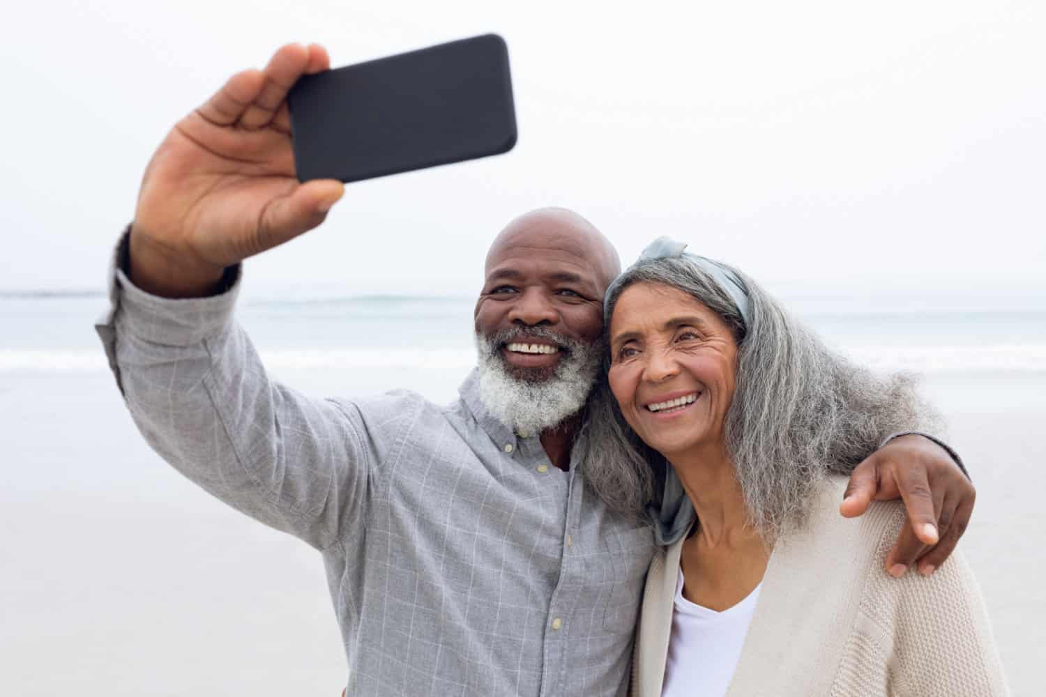 Retired couple taking a selfie by a body of water