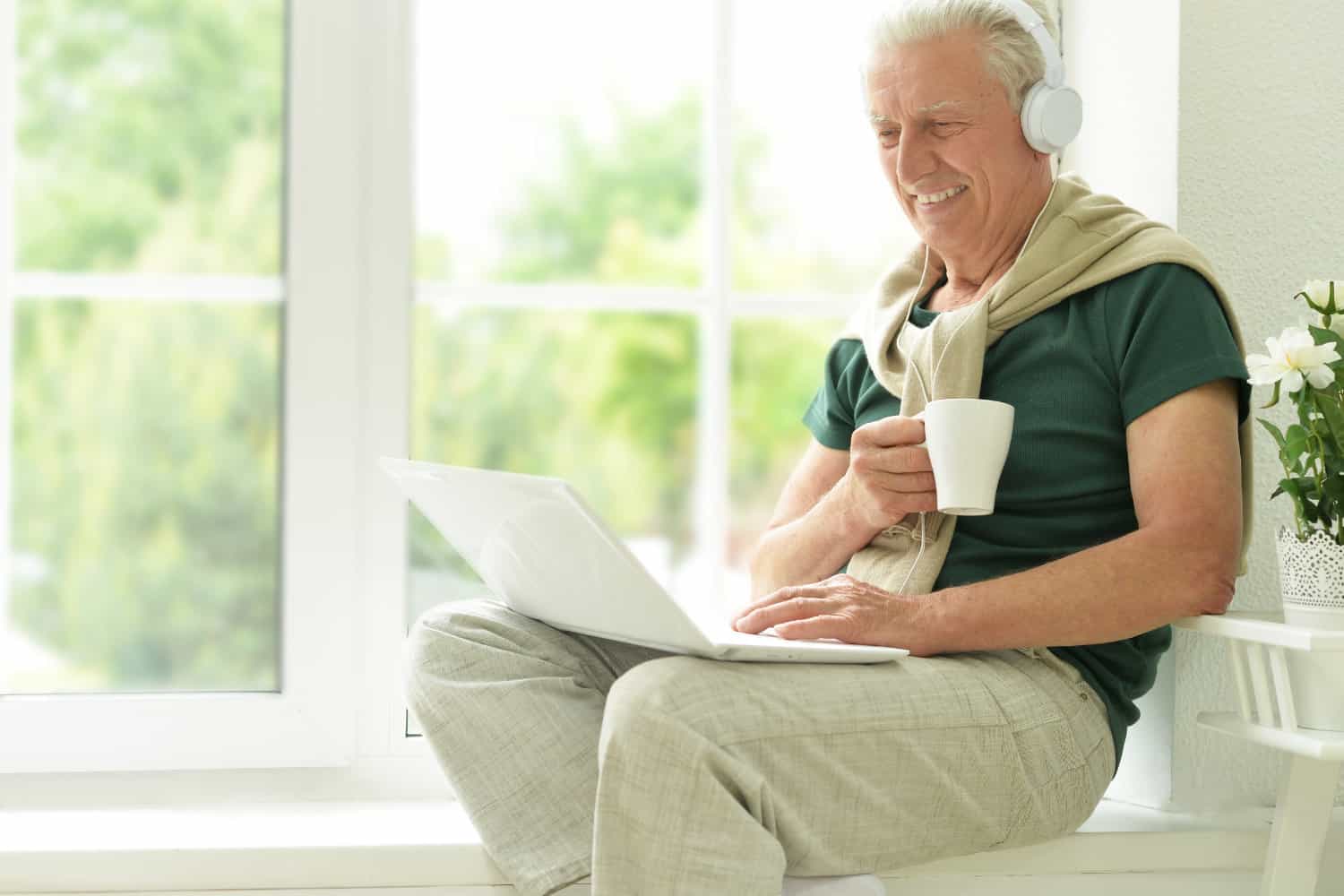 Retired man looking at an article on his laptop