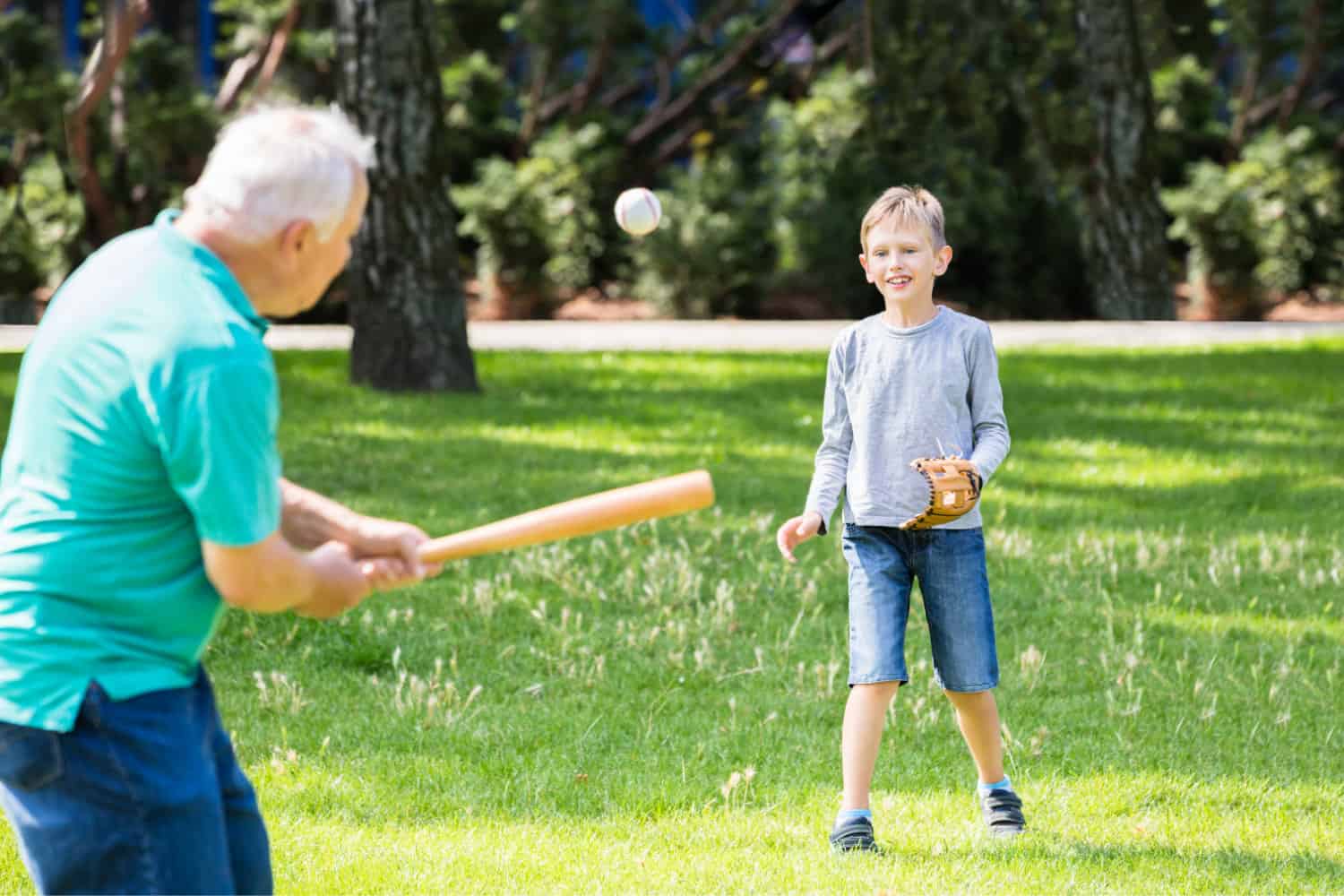 Grandpa playing baseball with grandson