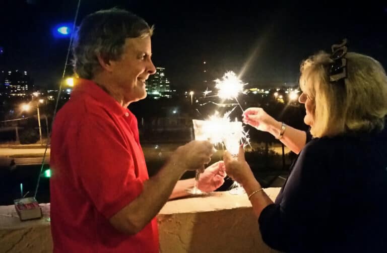 Retired couple enjoying sparklers and champagne