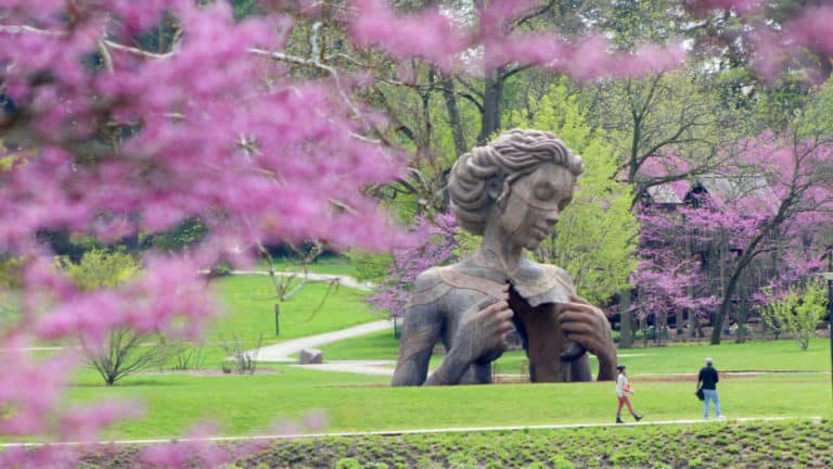 A woman and nature sculpture at The Morton Arboretum