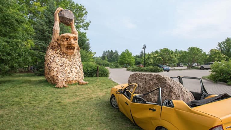 A Troll sculpture about to throw a boulder at The Morton Arboretum