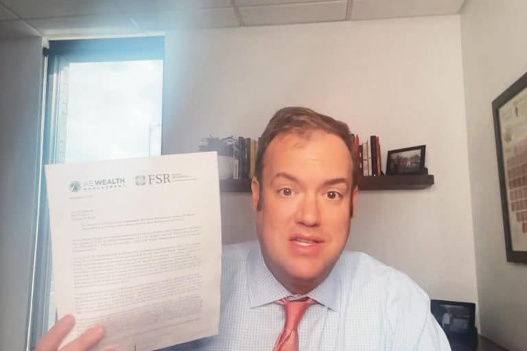 Josh holds up the letter from AE Wealth